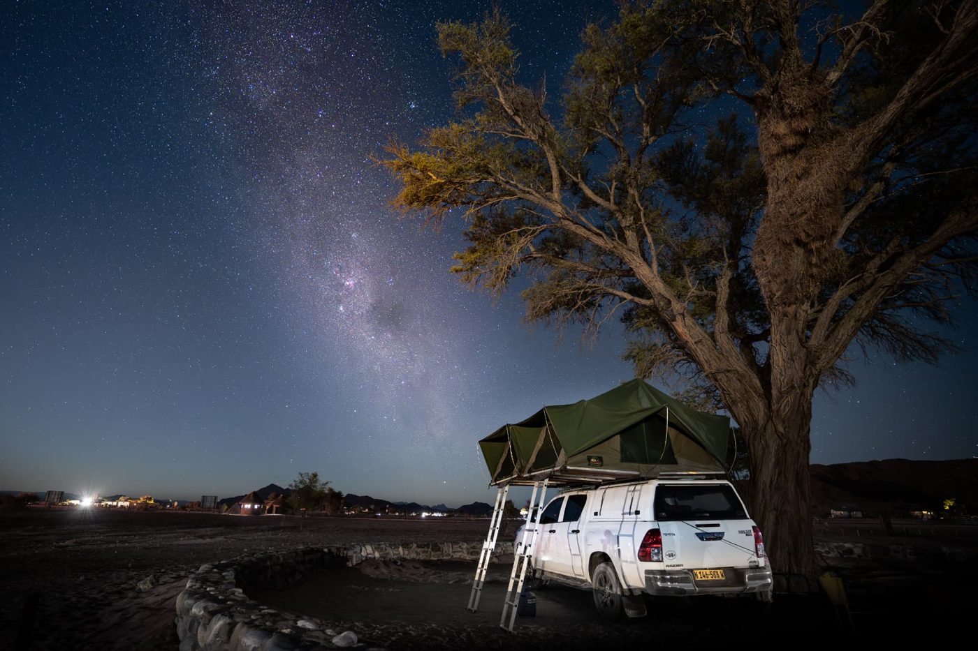 Toyota Hilux with rooftop tents open under the Milky Way at a Namibian campsite