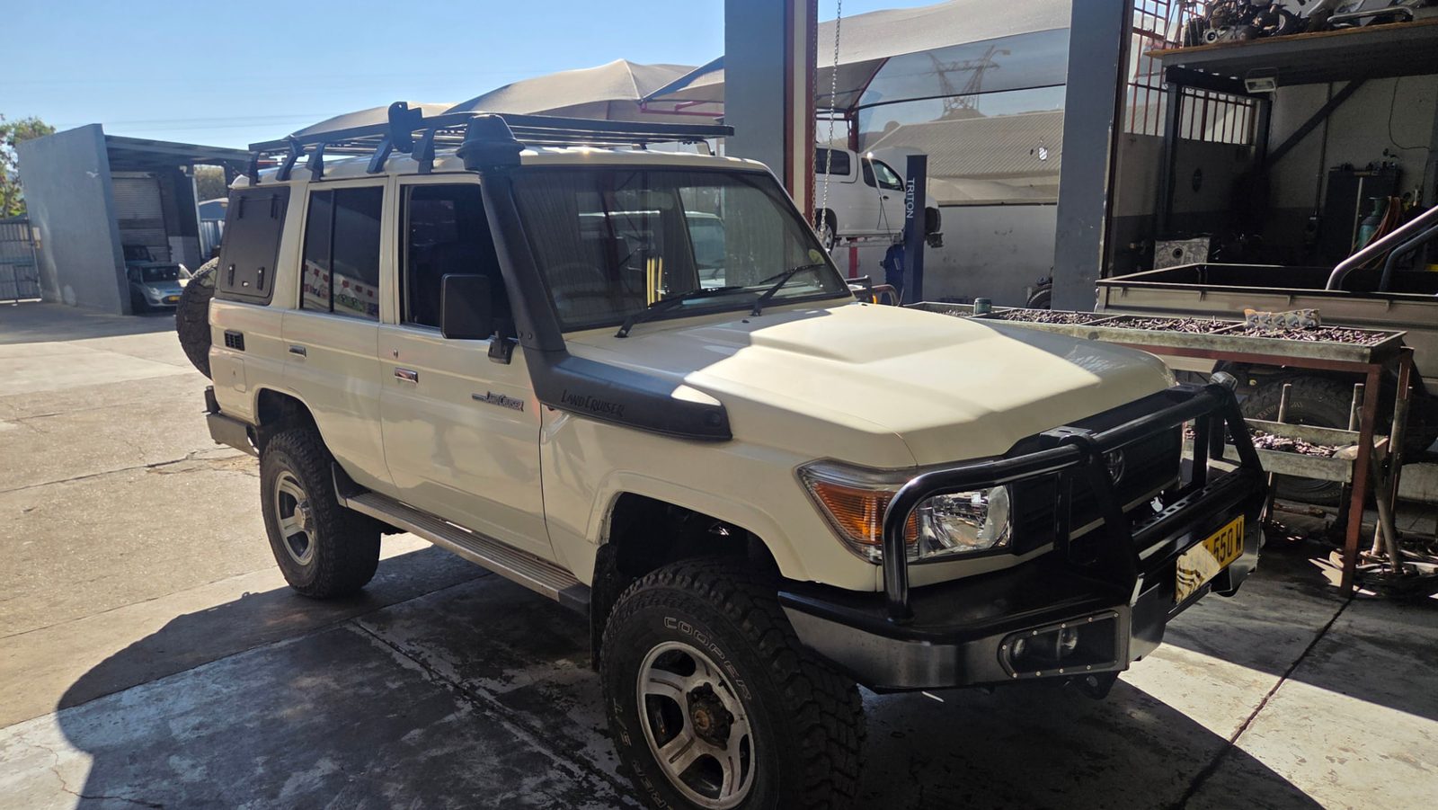 Toyota Land Cruiser 4x4 rental with bull bar and roof rack, tents stowed closed