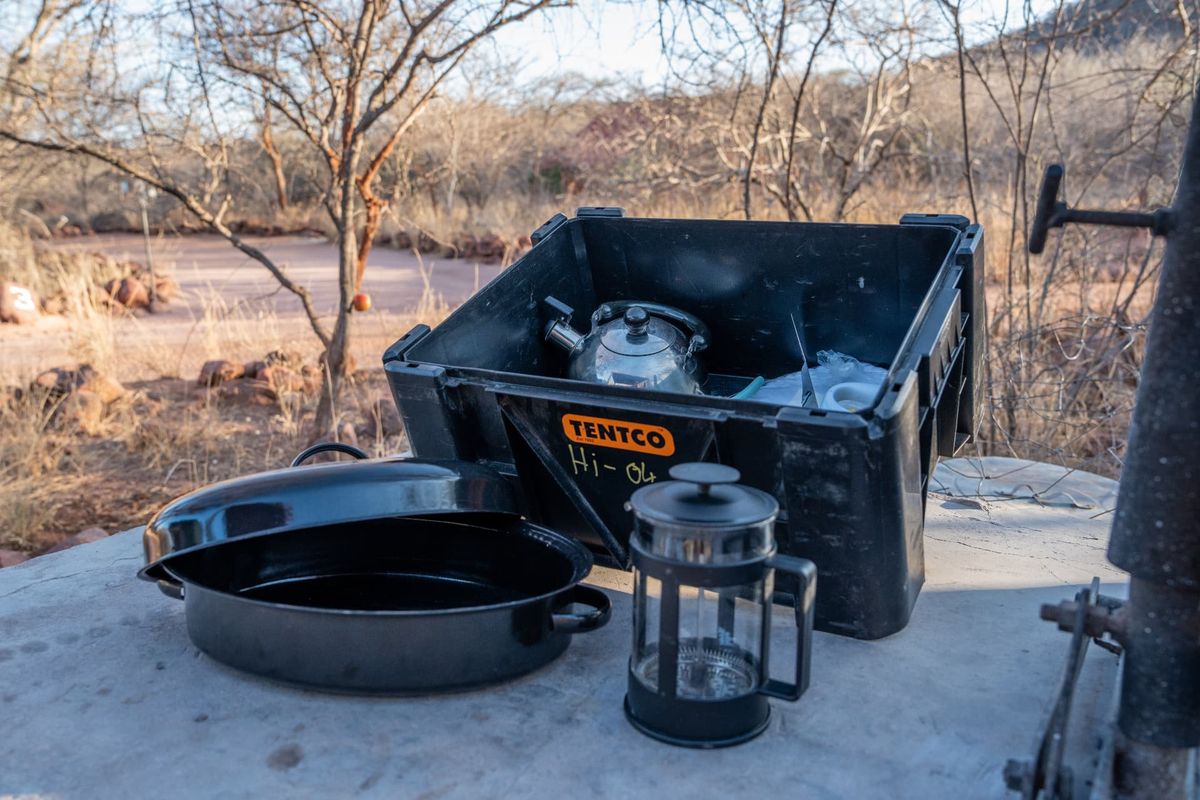 Camping cookware box with enamel roasting pan, stainless kettle and French press coffee plunger for a Namibia self-drive
